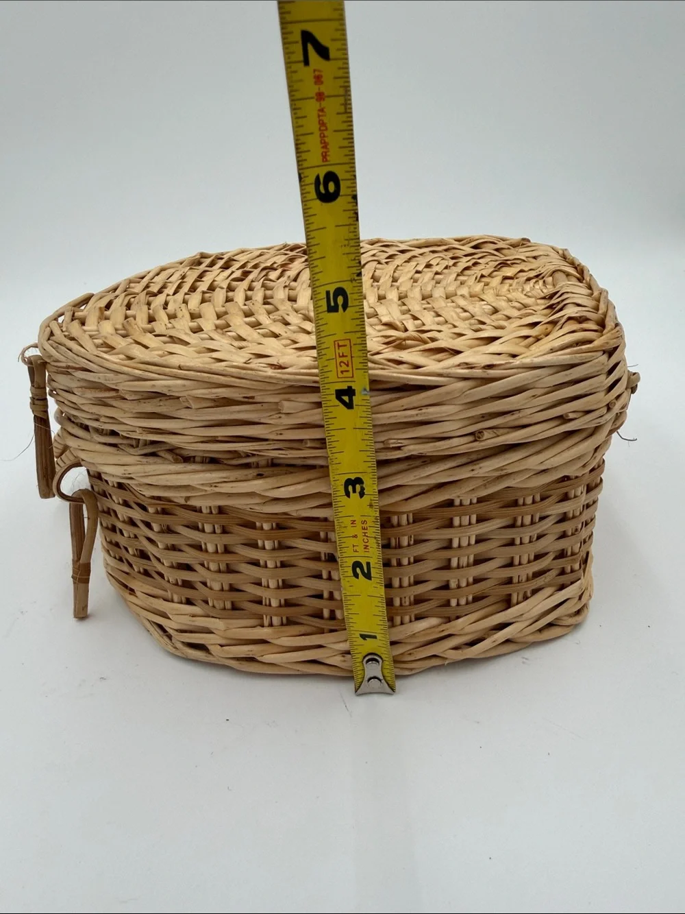 A Cute, charming vintage shell-shaped rattan storage basket with a front handle.
